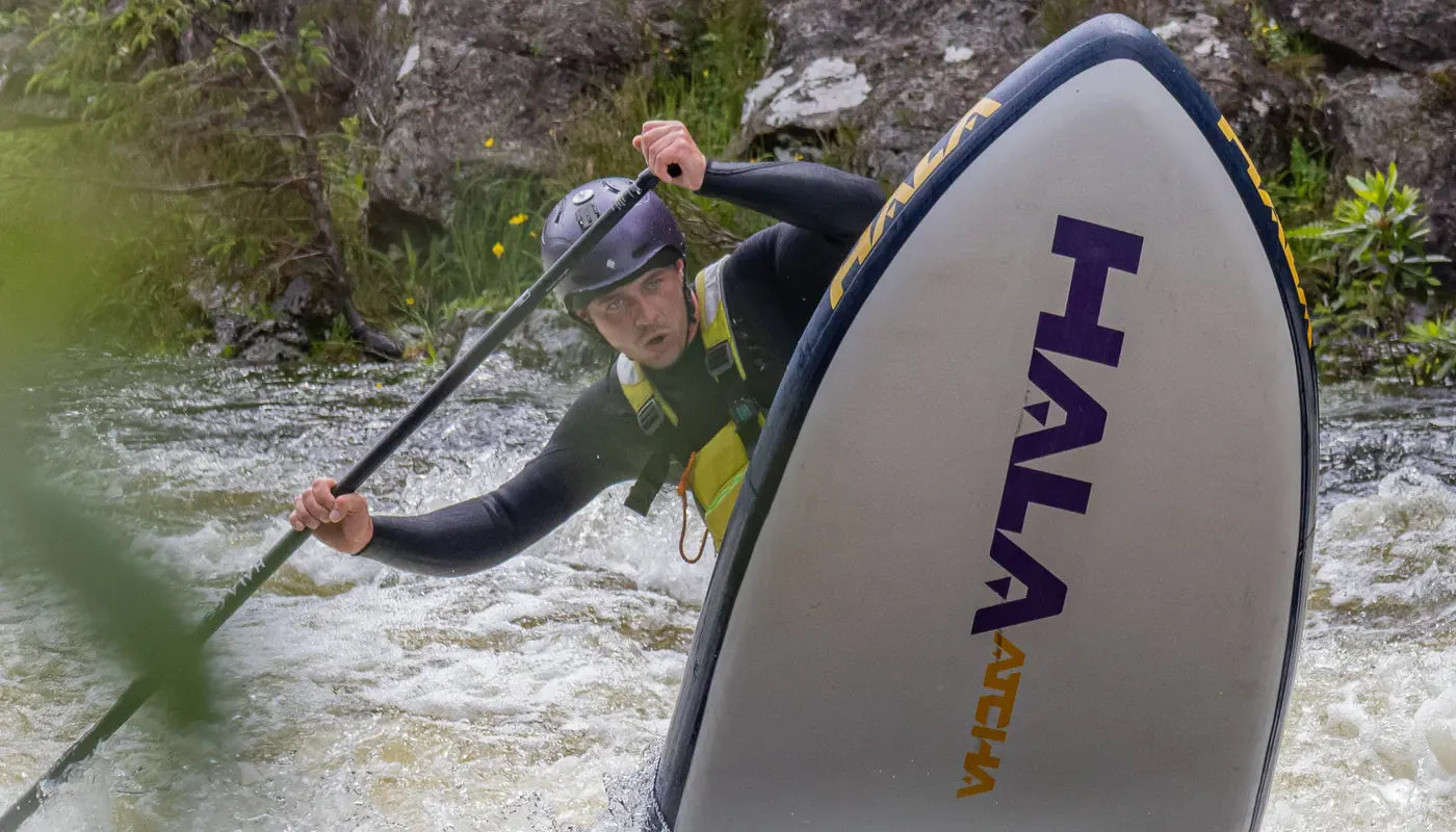 whitewater paddleboarder on a Hala Atcha inflatable SUP