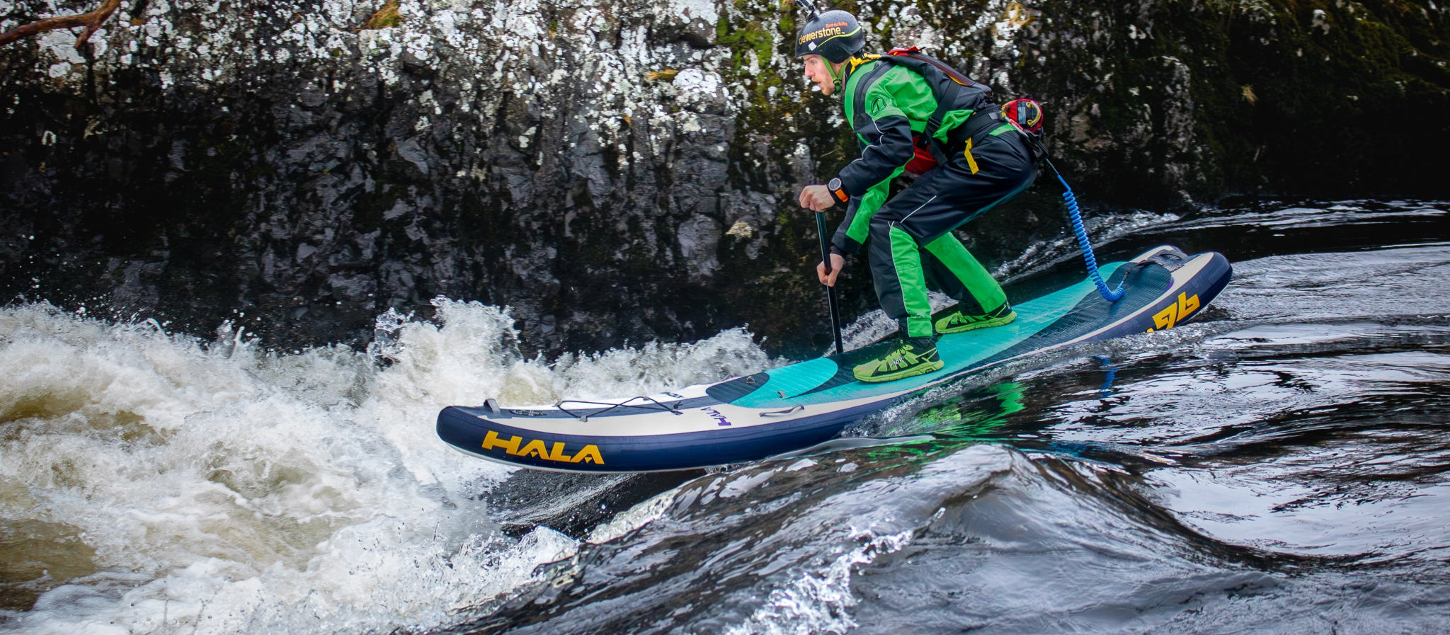 Hala stand-up paddleboard down a river with whitewater rapids